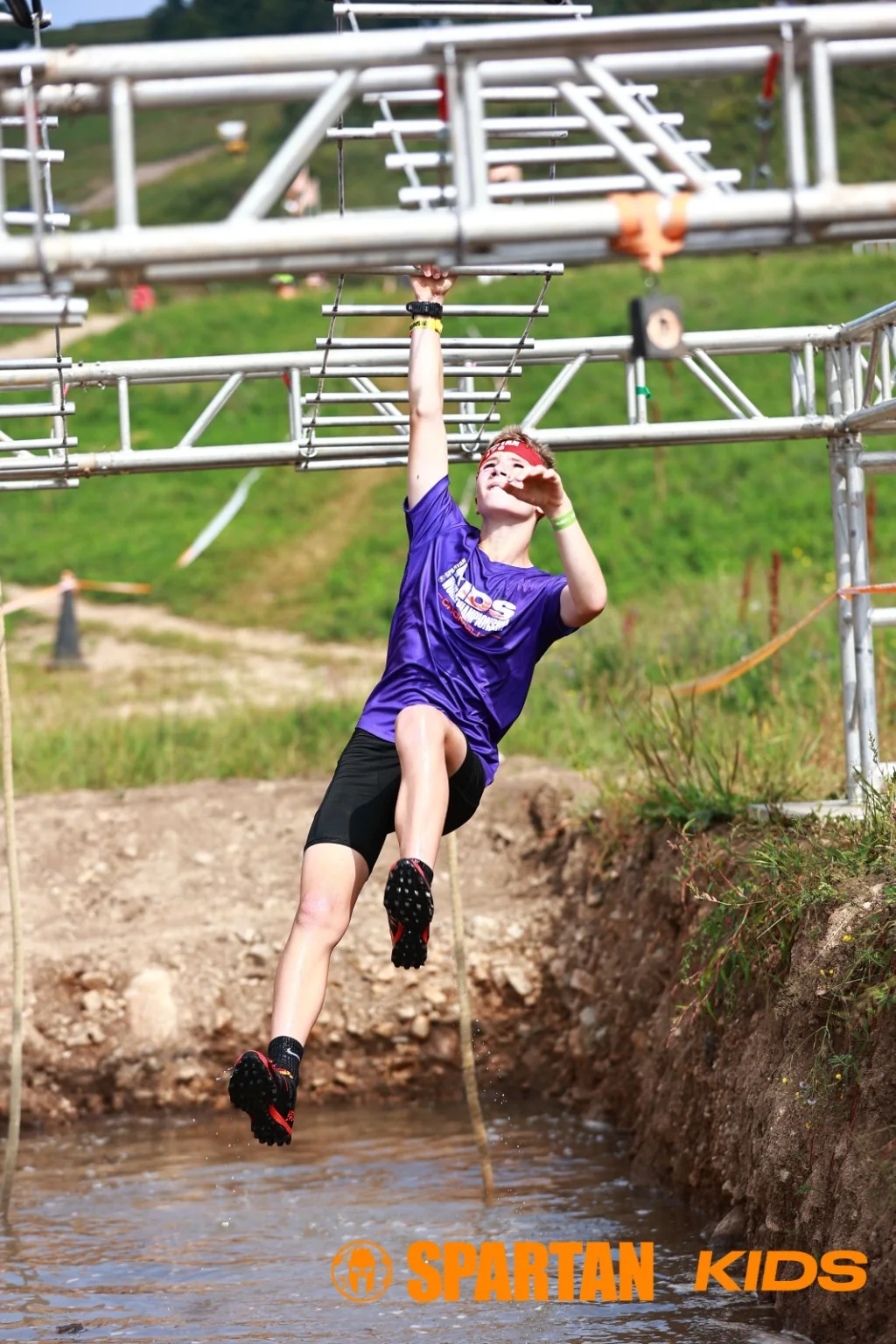 Harry crossing an overhead Spartan obstacle