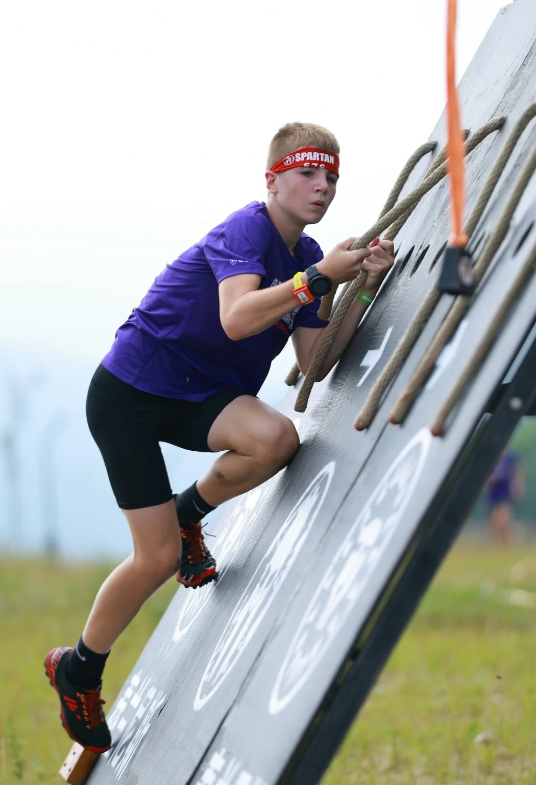 Harry climbing a Spartan obstacle wall